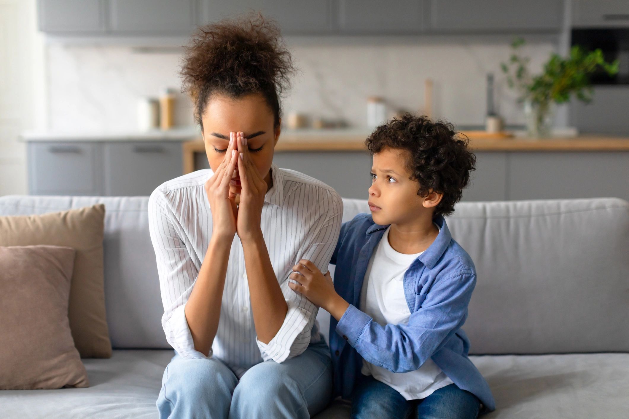 Worried mother with her comforting son